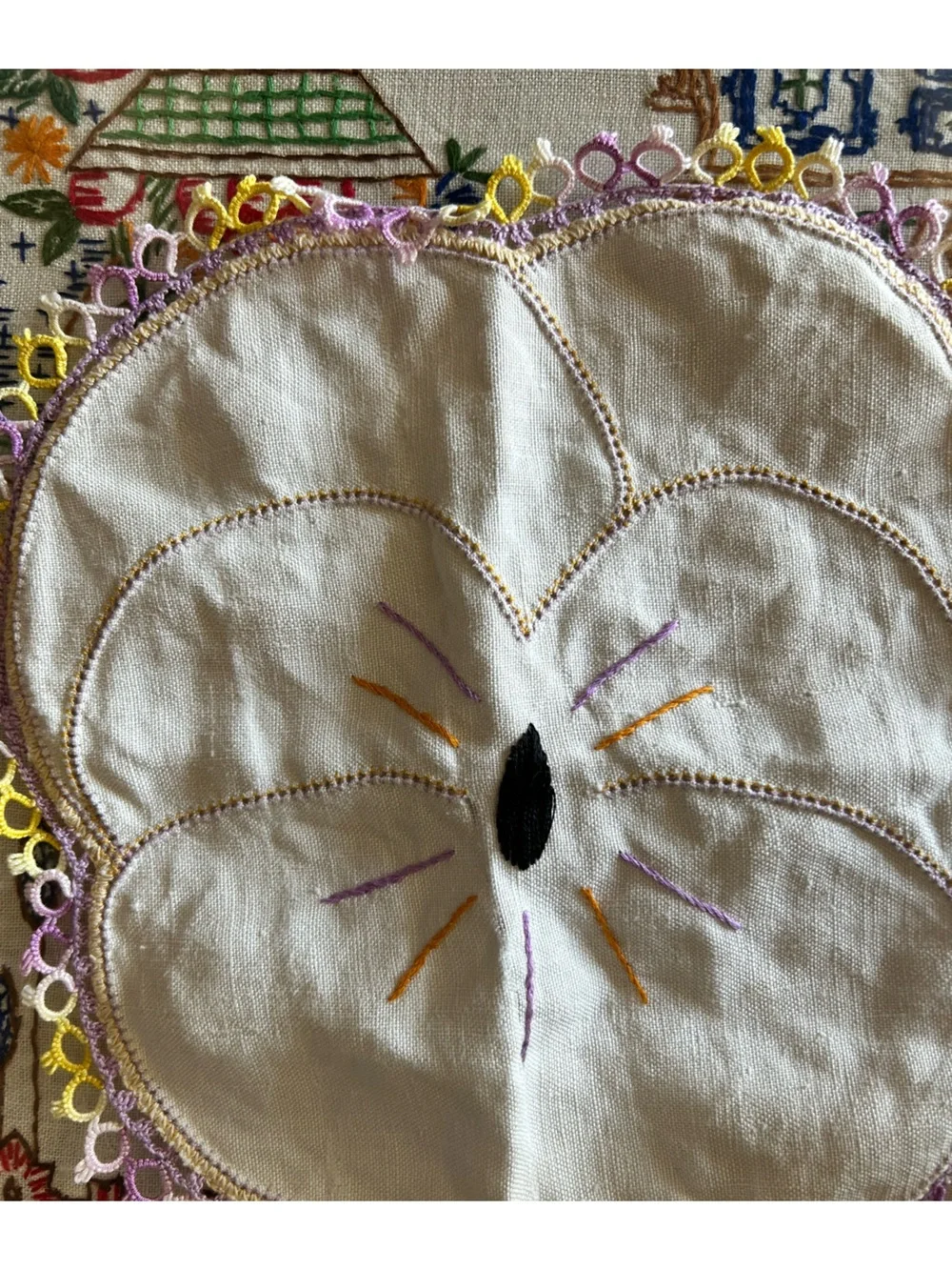 Vintage Hand-Embroidered White Floral Doily with Purple & Yellow Accents cat ?